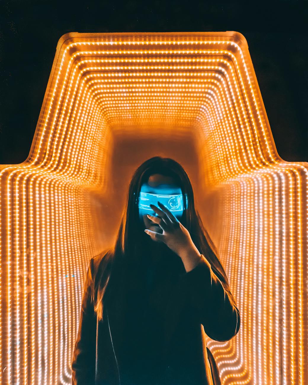 person in black top inside orange lighted room